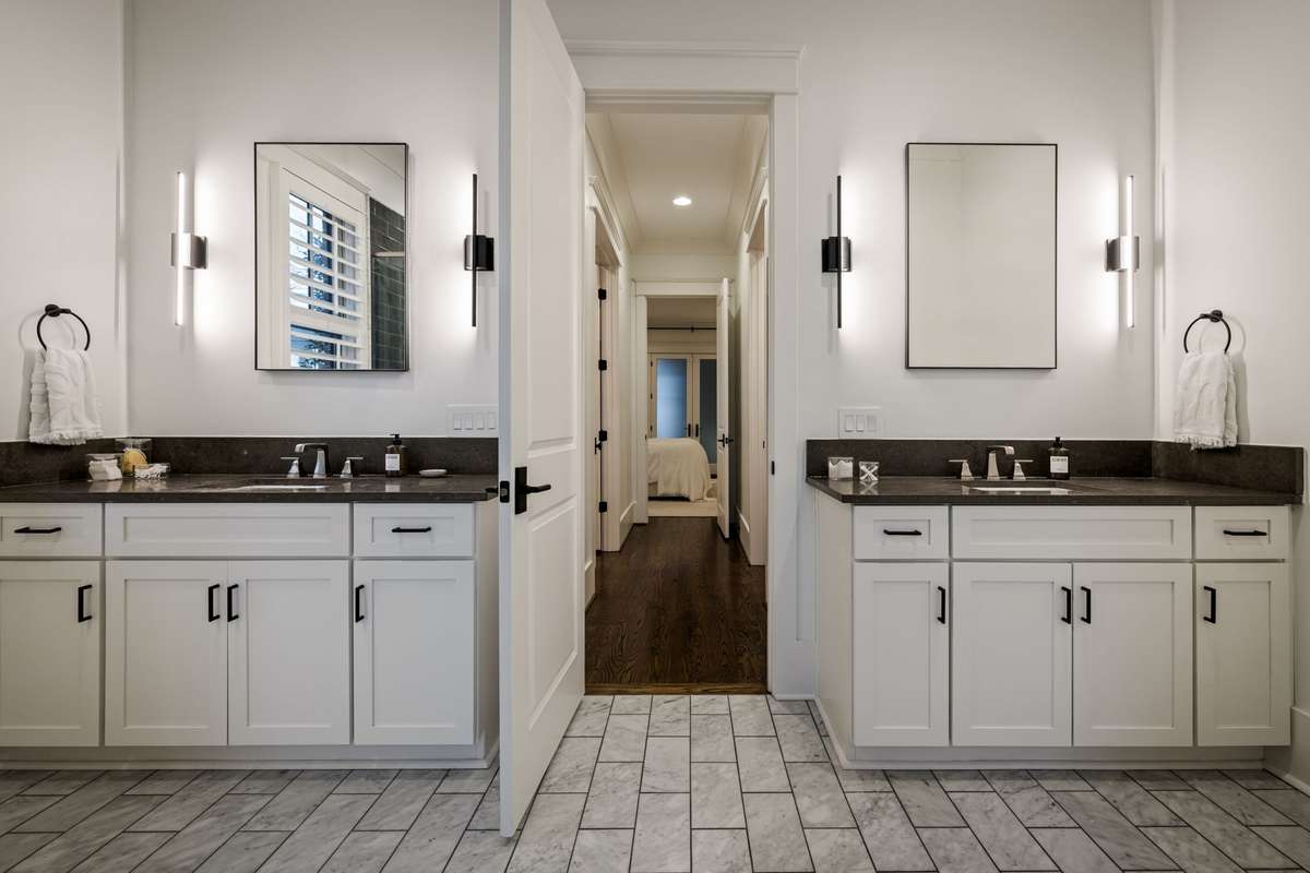 Primary bath with dual vanities and marble flooring