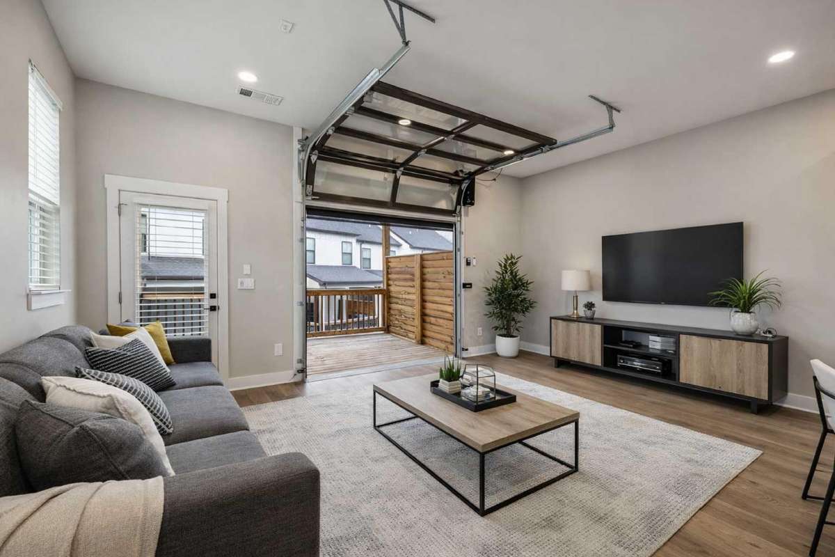 Welcome to 701 Stonecrest Dr! Living Room with Glass Garage Door & Retractable Screen that Opens to 2nd Level Covered Deck

Photo is virtually staged for marketing purposes