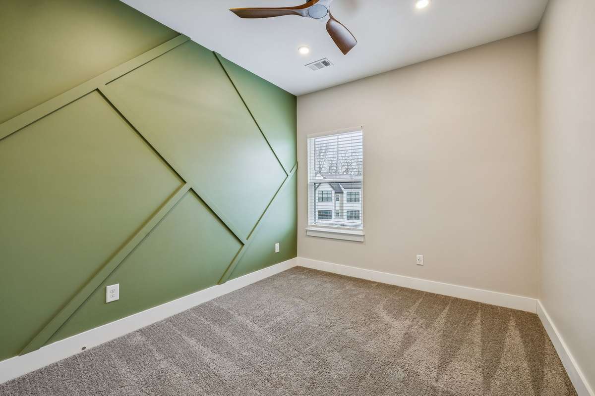 Guest Bedroom 1 with Accent Wall and Ceiling Fan