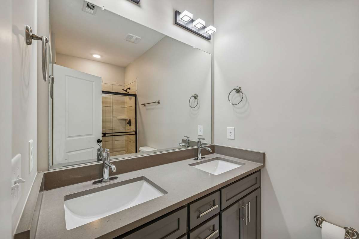 Primary Ensuite with Dual Vanity, Tile Flooring & Tile Shower with Glass Door