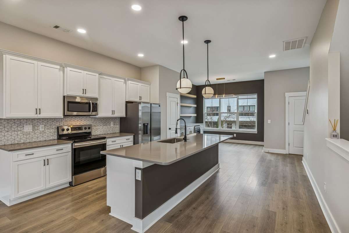 Chef's Kitchen with Quartz Countertops, Tile Backsplash, SS Appliances & Pantry