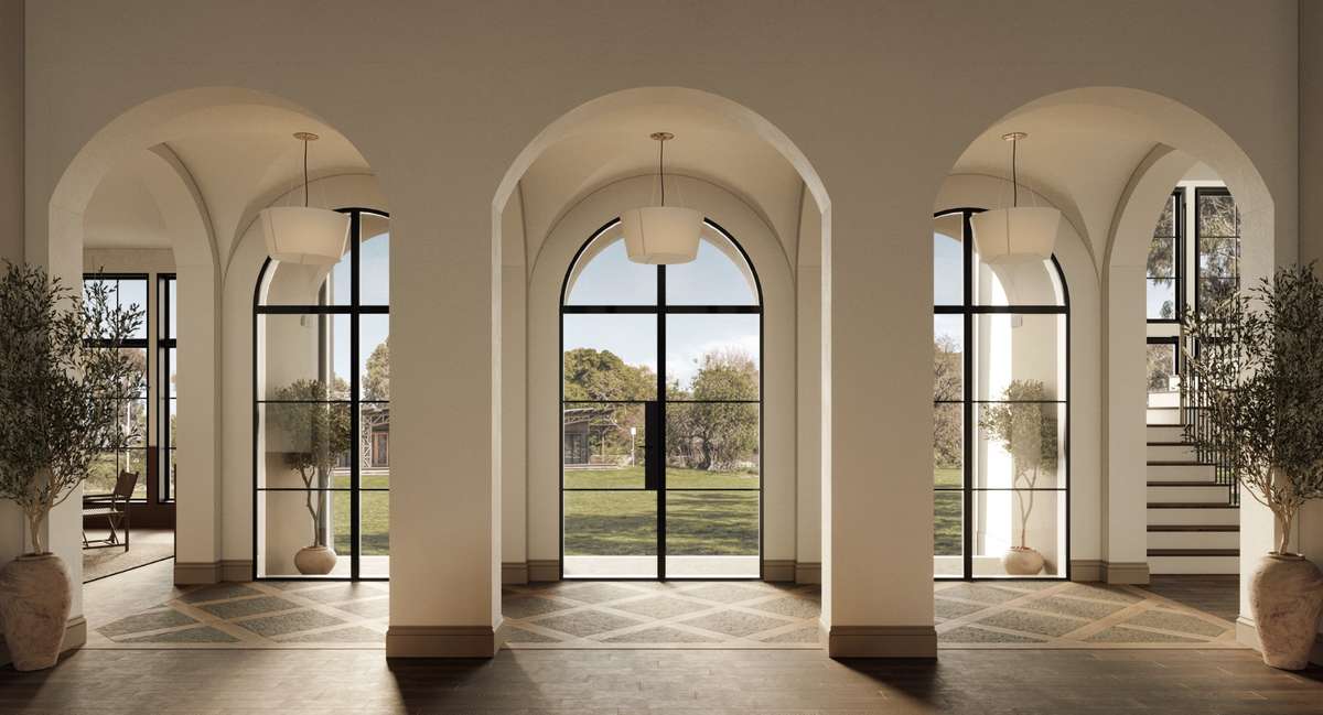 The grand entry gallery features groin-vaulted ceilings, elegant arched openings, and showcase windows that fill the space with natural light.