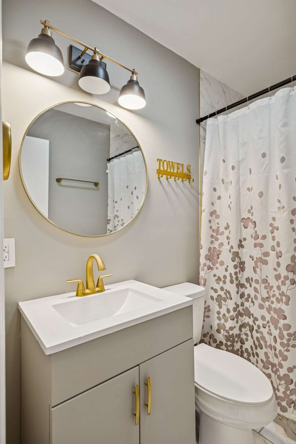 Newly renovated full bath features modern lighting and mirror! 550 Harding Place, #F 107, Nashville, TN 37211