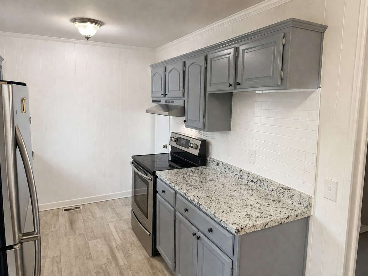Updated kitchen featuring granite countertops and ample cabinet space