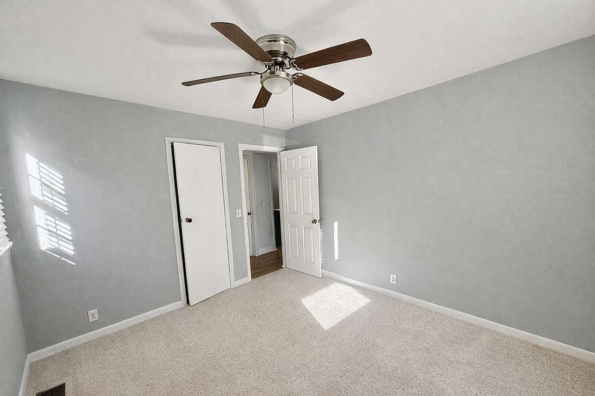 Freshly painted bedroom with natural light and ceiling fan