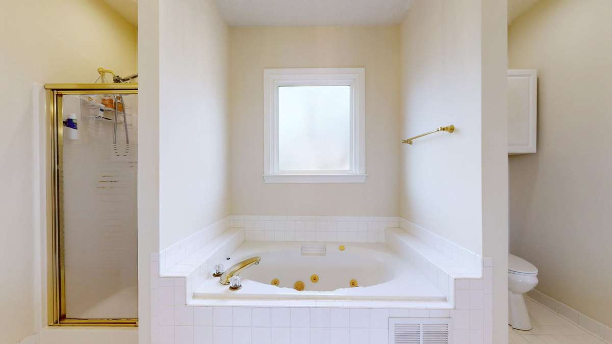 Primary bath with two walk in closets.