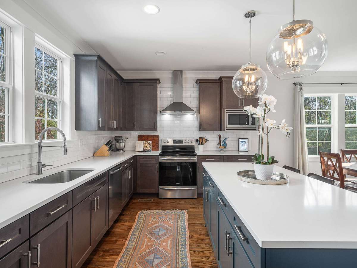 The kitchen opens to the informal dining space and allows for entertaining family and friends with ease