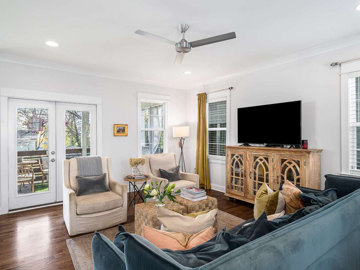 The double doors off of the living space open to a covered porch and fenced back yard