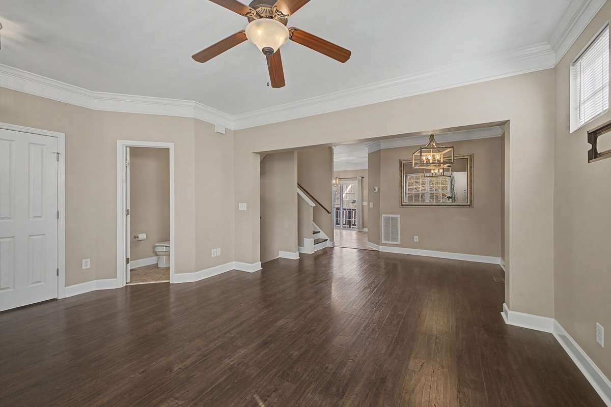 Natural light and room for several sofas and chairs.  View into the large Dining Room able to accommodate a large dinner gathering.