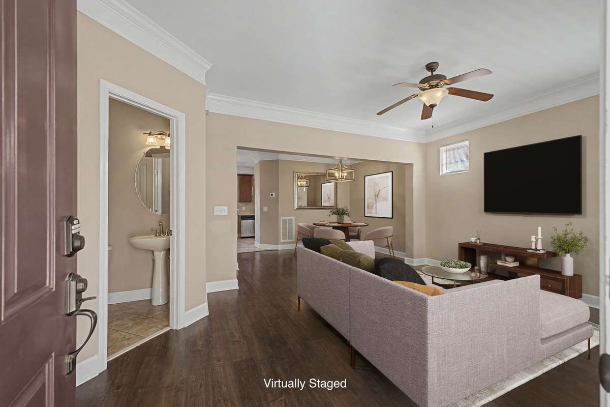 Entry view of the Great Room.  Easily accessible Half Bath.  View looking from front door through Great Room toward Dining Room.