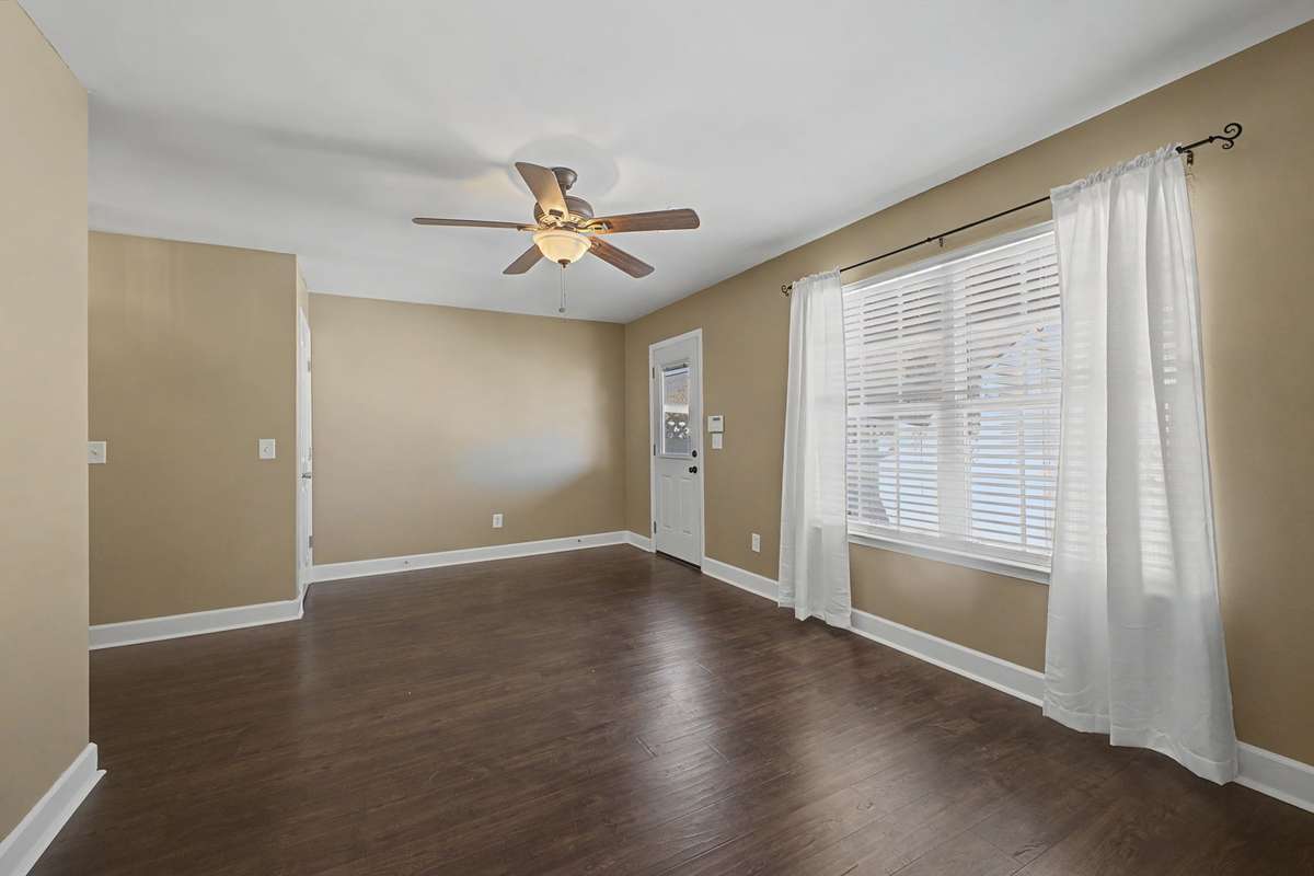 Lower level Living Area looking at door to backyard and the 2 car parking area.