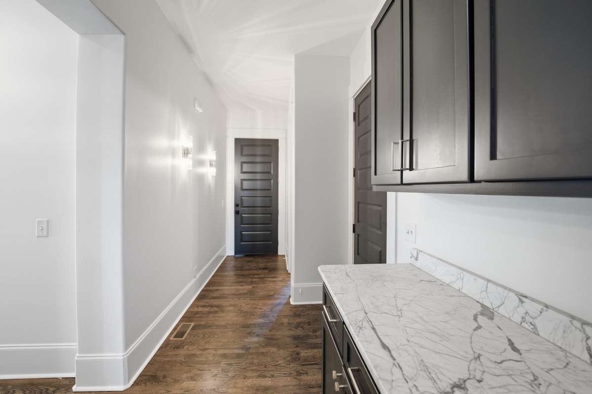 main downstairs hallway with staging area looking at garage door