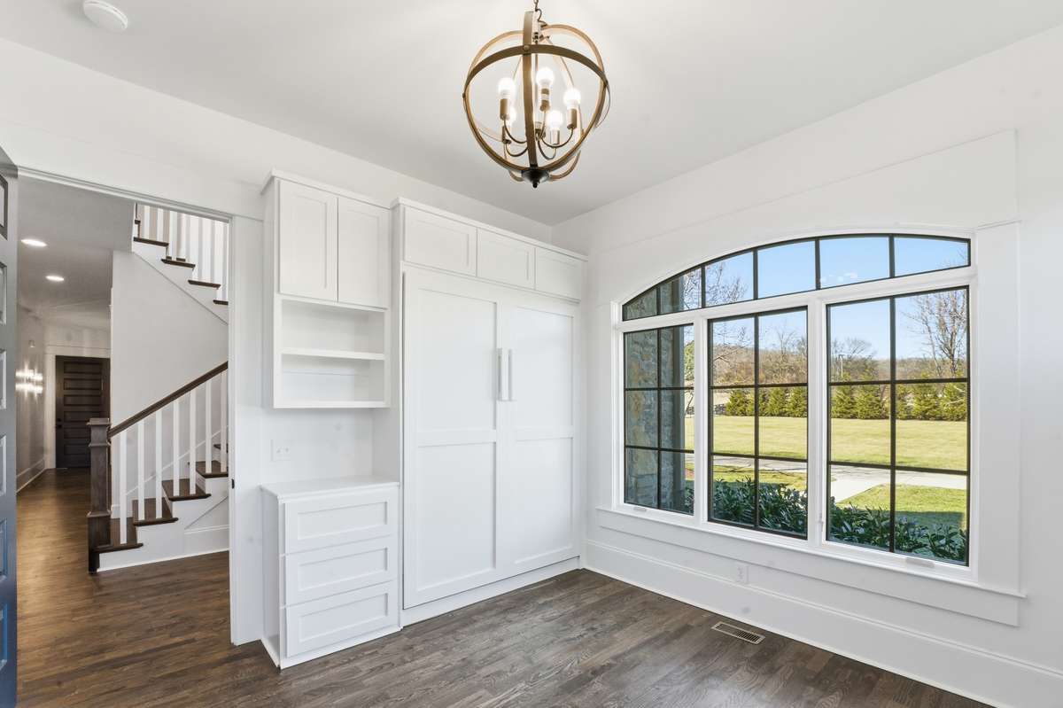 downstairs secondary bedroom showing murphy bed and storage