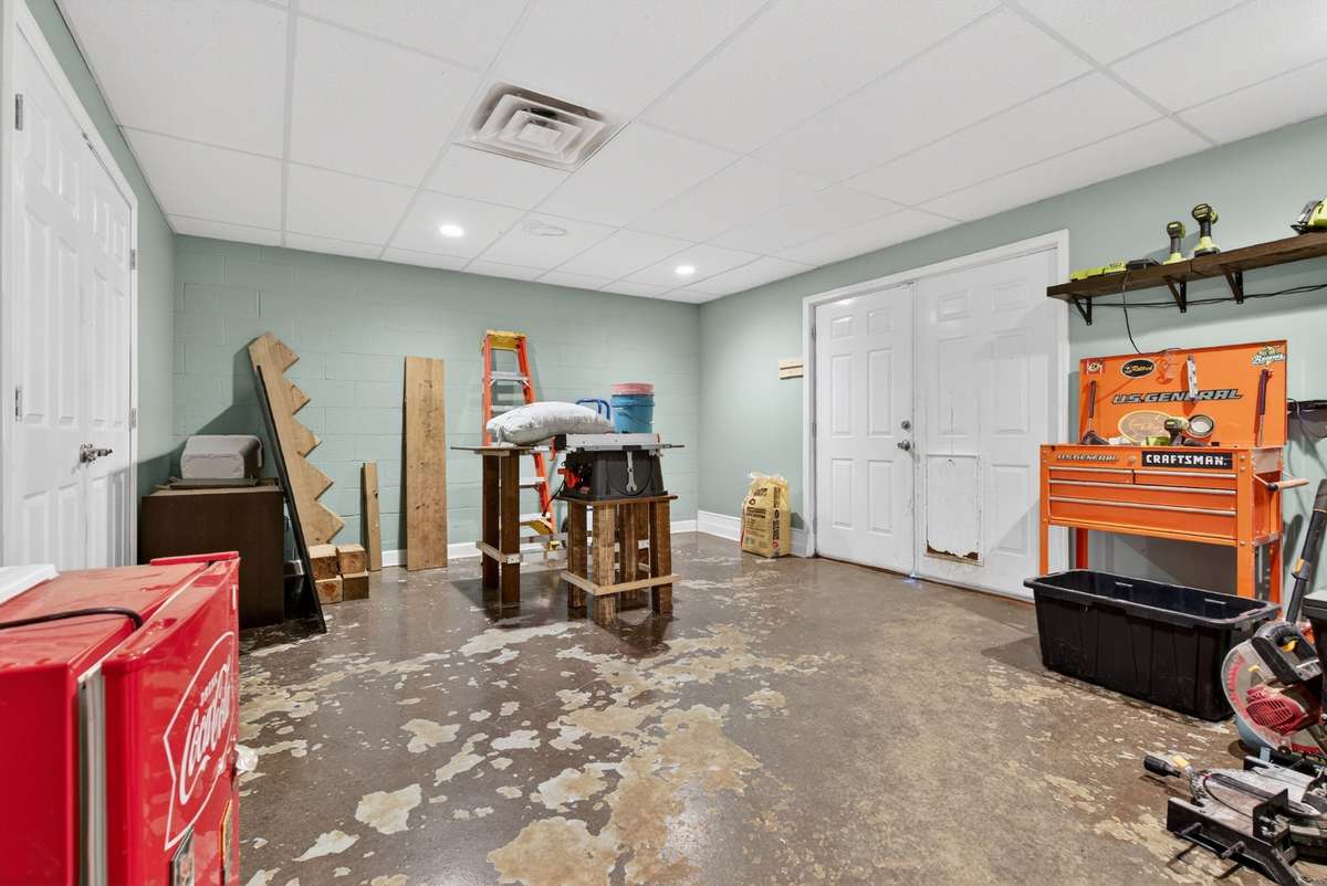Perfect for hobbyists or extra storage needs — storage space behind the left double doors, plus backyard access with a doggie door on the right.