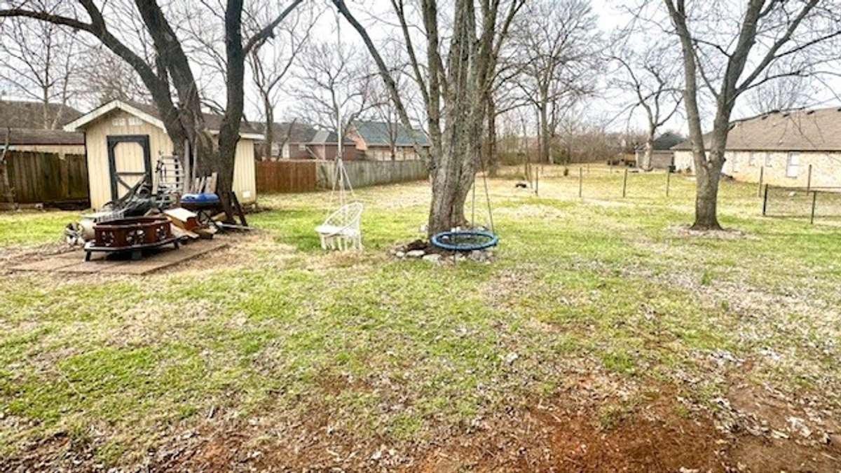 large back yard with shed house