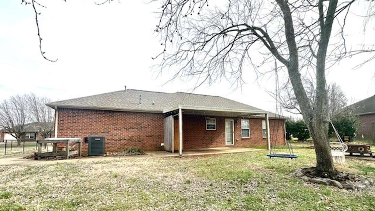 back of house with cover patio