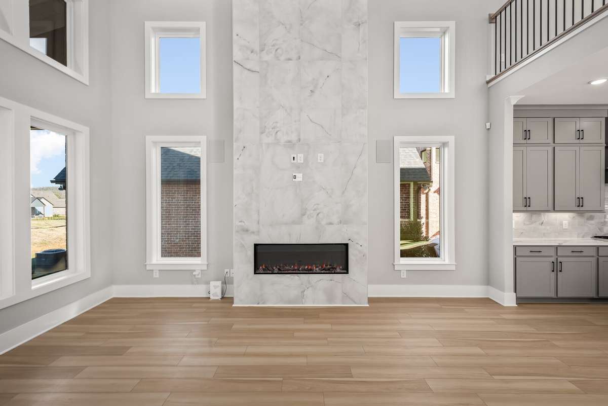 Living / Family room showcases a stunning 2 storey tiled fireplace
