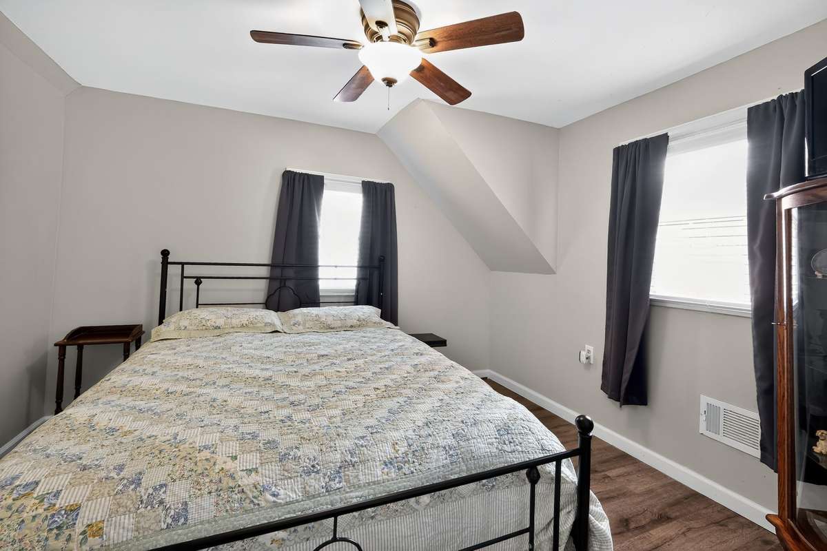 Upstairs bedroom 1 with large closet and ceiling fan.