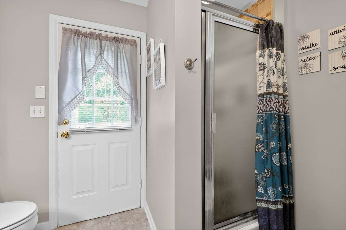 Bathroom 2 with stand up shower doubles as a mudroom with outside entrance.