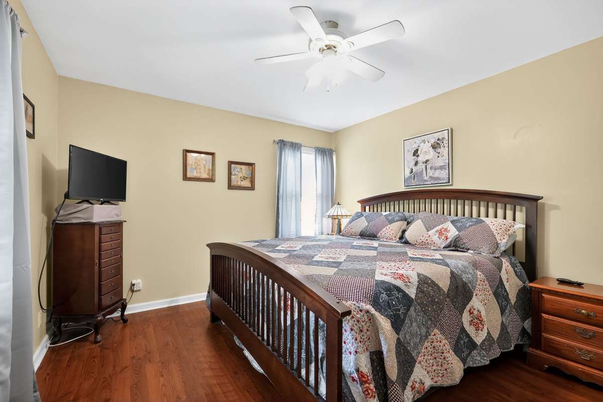 Upstairs bedroom 4 has new flooring, neutral paint and a ceiling fan.