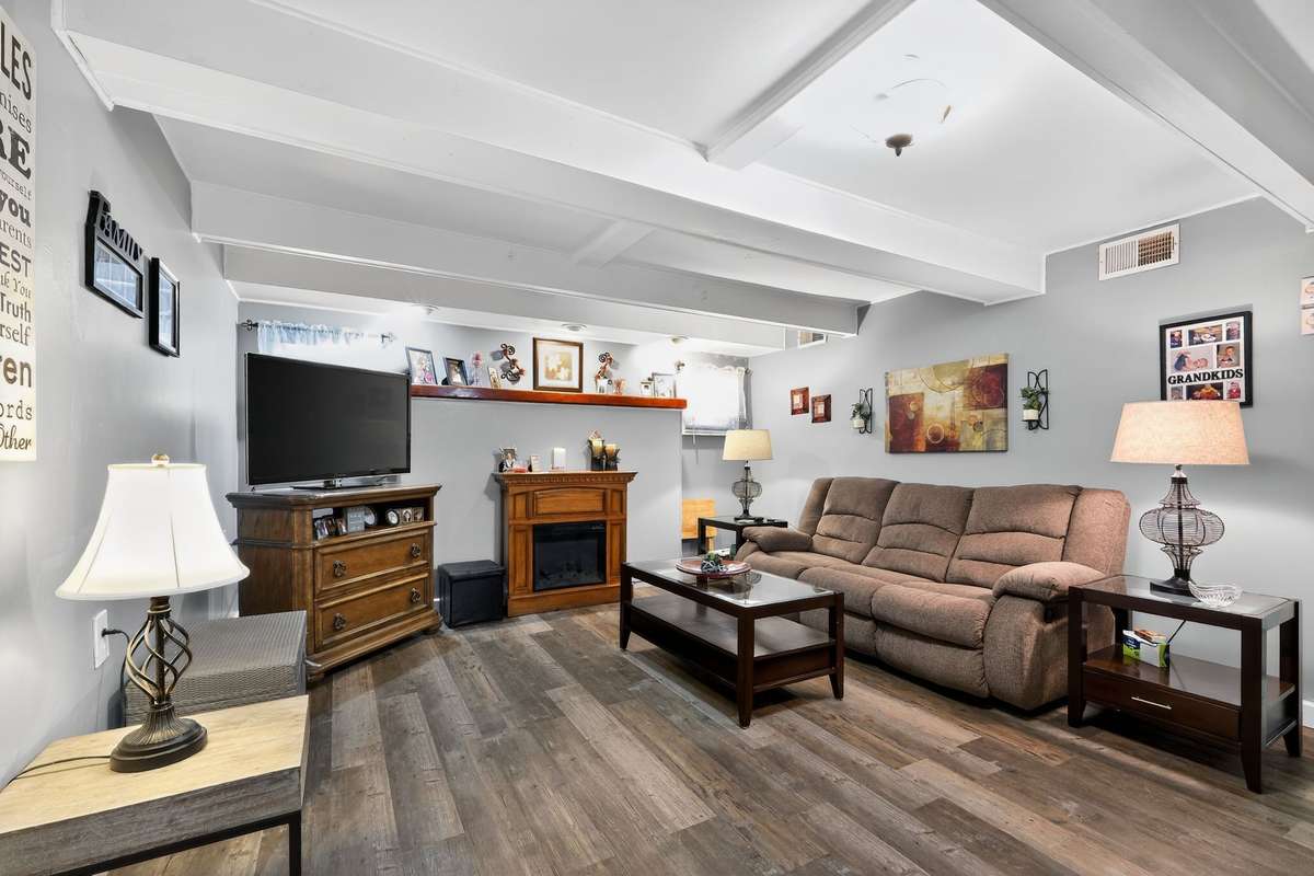 This den is cozy and quiet on the back of the home.  Storm shelter access conveniently located on the rear wall.