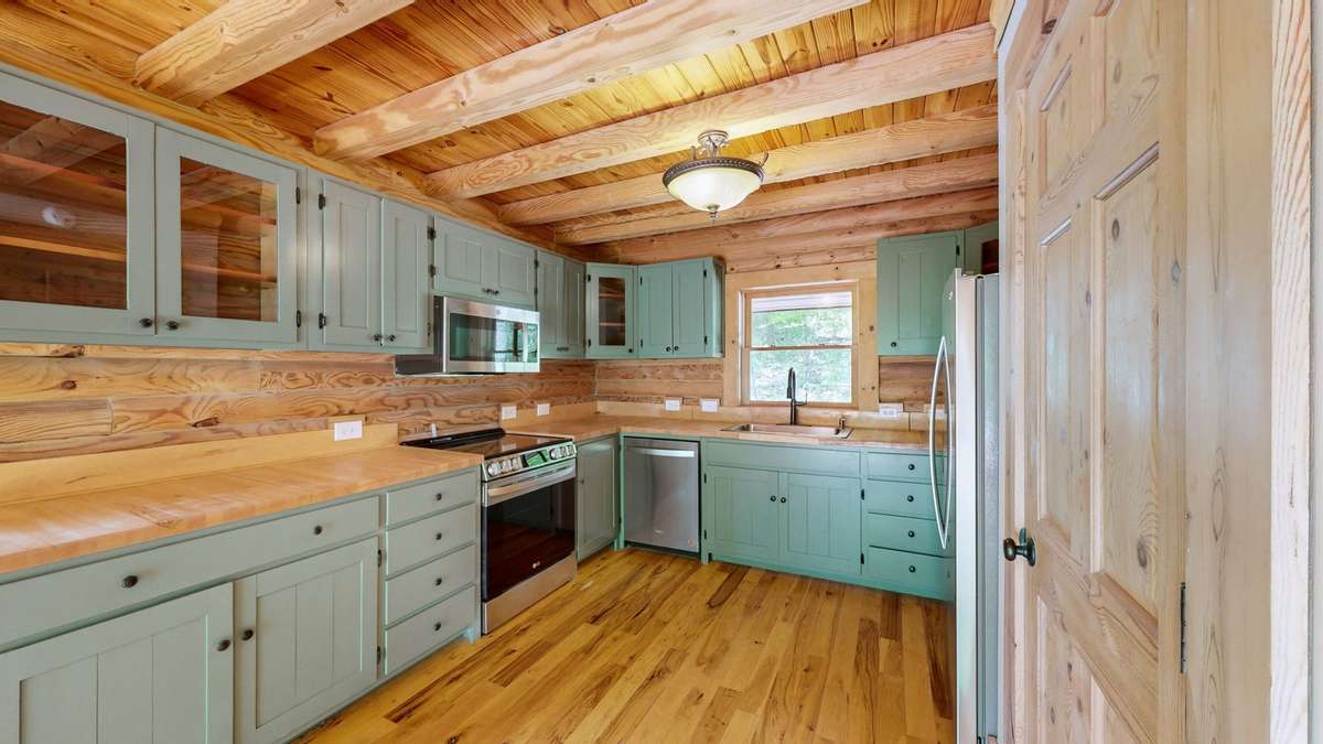 Updated kitchen with all new appliances. Gorgeous butcher block countertops maintain the remote cabin feel.