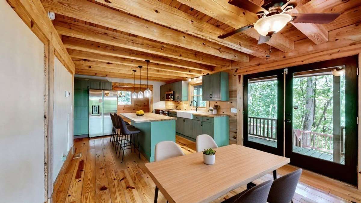 The open kitchen design offers great entertaining space.  Whether lounging in the living room or dining on the lower deck, the kitchen is the heart of the cabin!