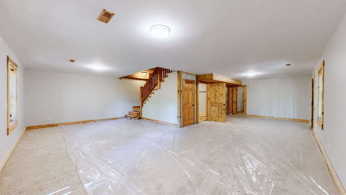 Don't mind the plastic... it covers the brand new carpet :)  the large open space connects two additional flex rooms.  Looking for more sleep space?  Want a awesome game room? What about a theater with huge comfy furniture?