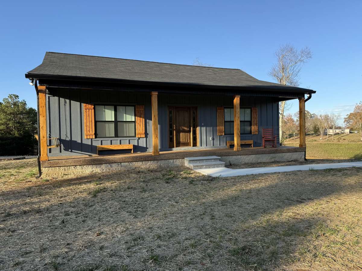 Home features concrete sidewalk and Rocking Chair Front Porch.