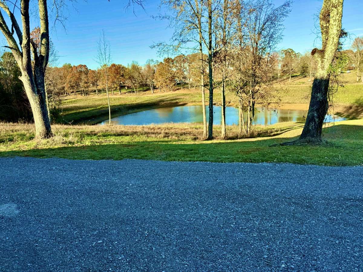 Huge Gravel Parking Area next to the home overlooking your pond