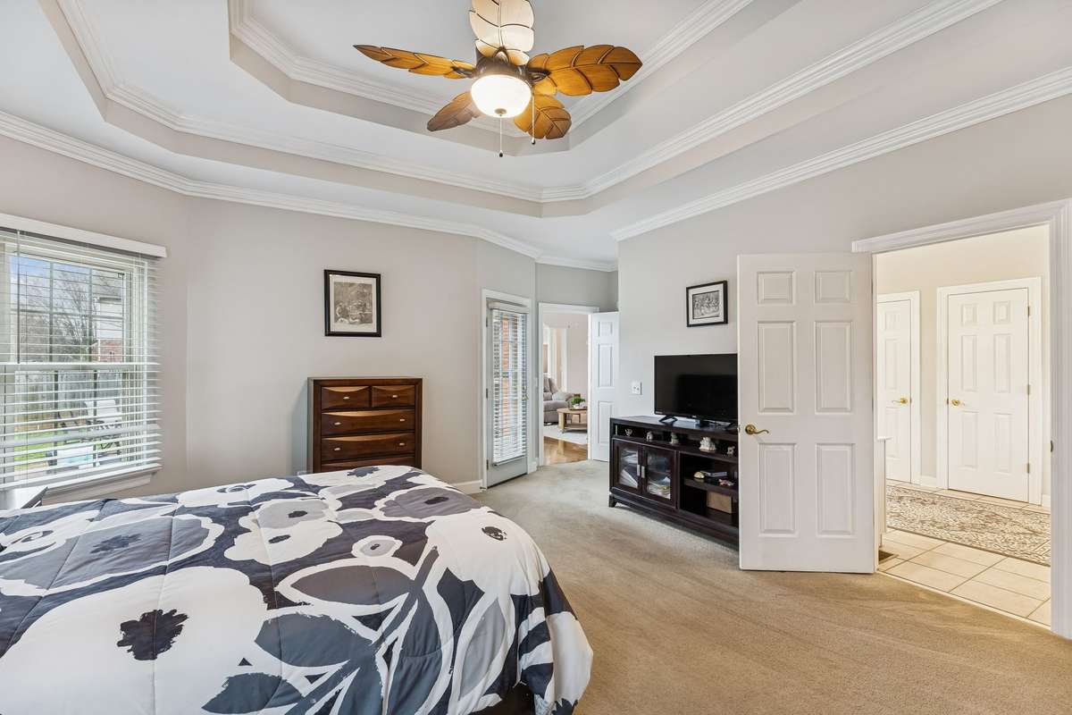 The spacious primary suite features an intricate trey ceiling with crown molding detail, creating an elegant focal point!  2409 Amber Glen Court, Murfreesboro, TN 37128