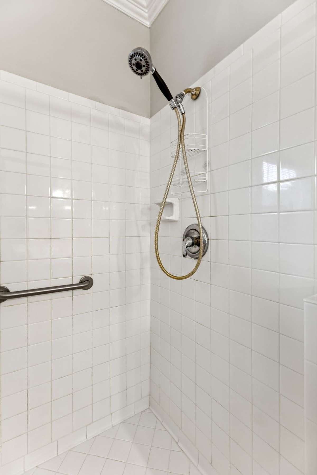 Glass enclosed shower is fully tiled and includes a pull down shower head. 2409 Amber Glen Court, Murfreesboro, TN 37128
