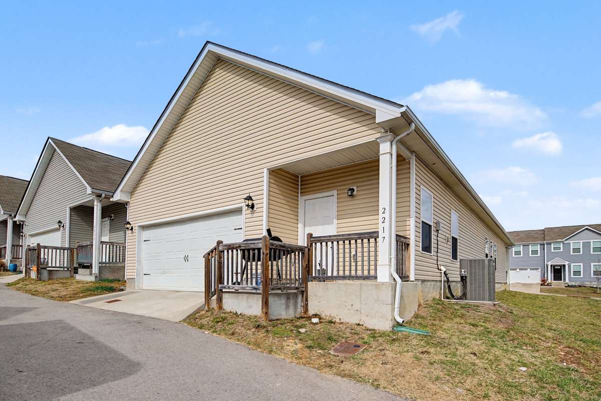 Convenient rear-entry two-car garage with additional parking pad. Private side entrance and deck area ideal for grilling and outdoor gatherings.