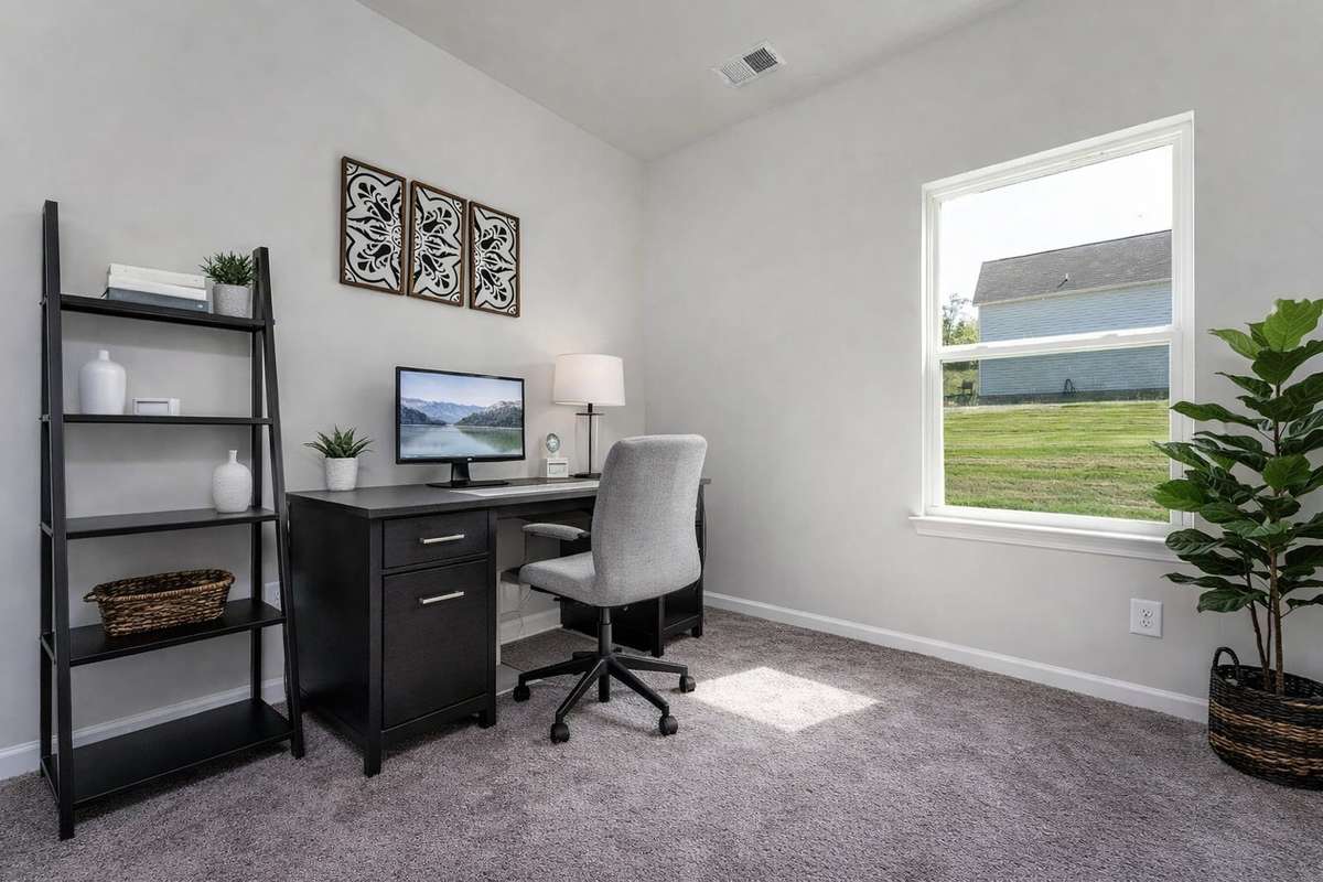 Model home photo of the second bedroom, used as home office.
