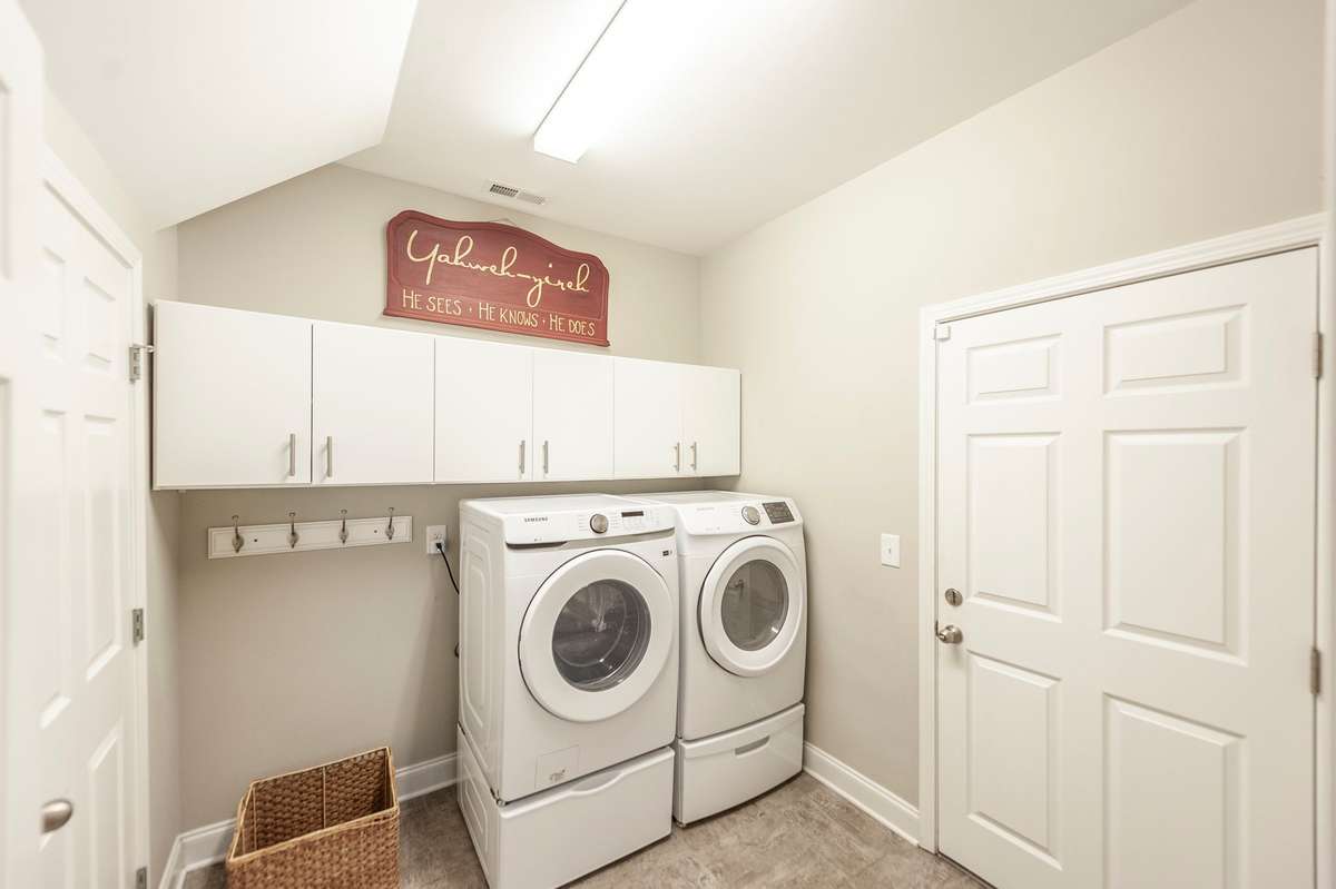 The utility room offers built in cabintery, a huge utility closet and garage access