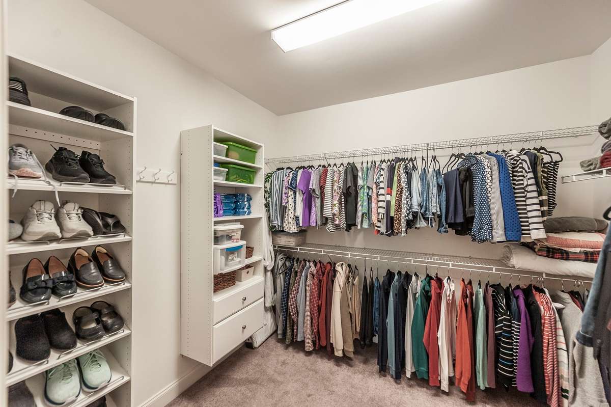 Huge walk in closet with Built ins to help keep clothes organized and tidy