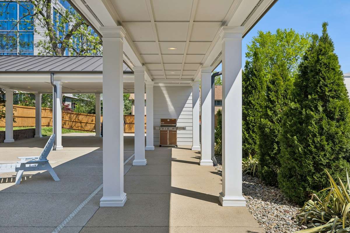 A covered breezeway connects the architectural pavilion to the home.