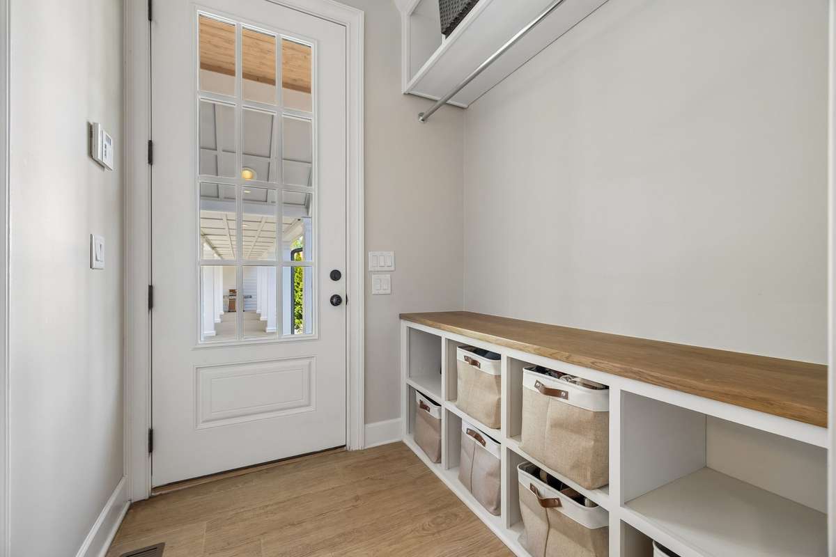 mudroom and 1/2 bath (one of 3 half baths) offers added convenience for pool parties and outdoor entertainment.