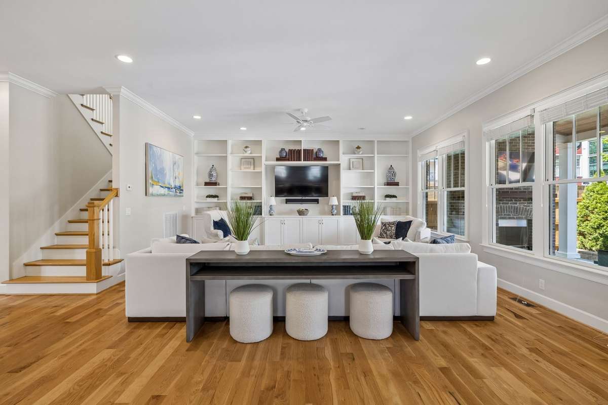 Custom built in shelves make a beautiful focal point in the great room. The room is bathed in natural light.
