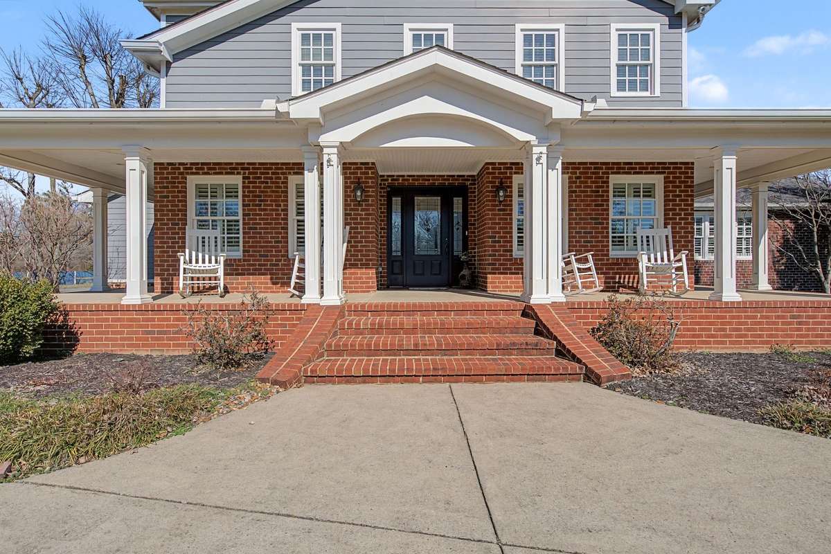 Beautiful covered porch wrapping three sides of the home.