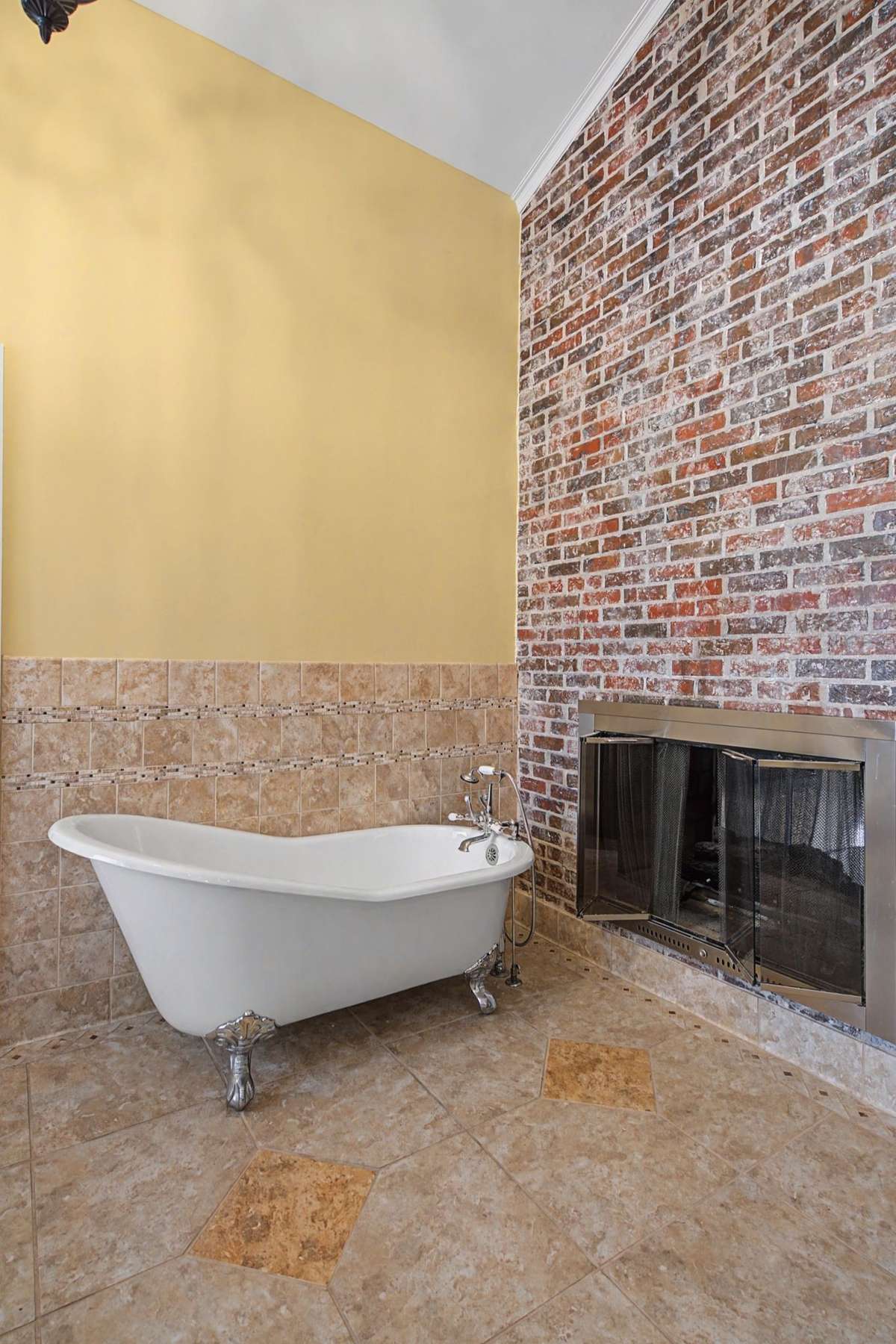 Clawfoot tub in front of the gas fireplace