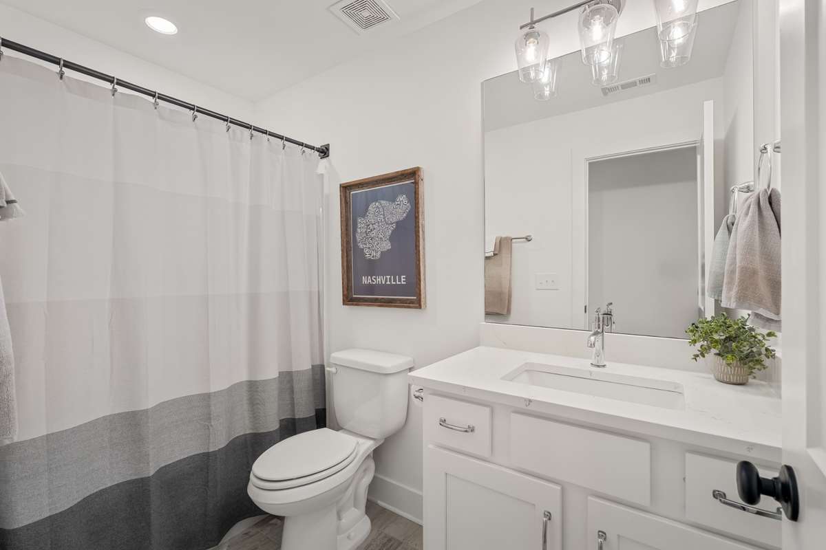 The third bathroom located upstairs between the bedrooms. This is not a jack and jill bath but is conveniently located near both bedrooms and the loft for guests or entertaining.