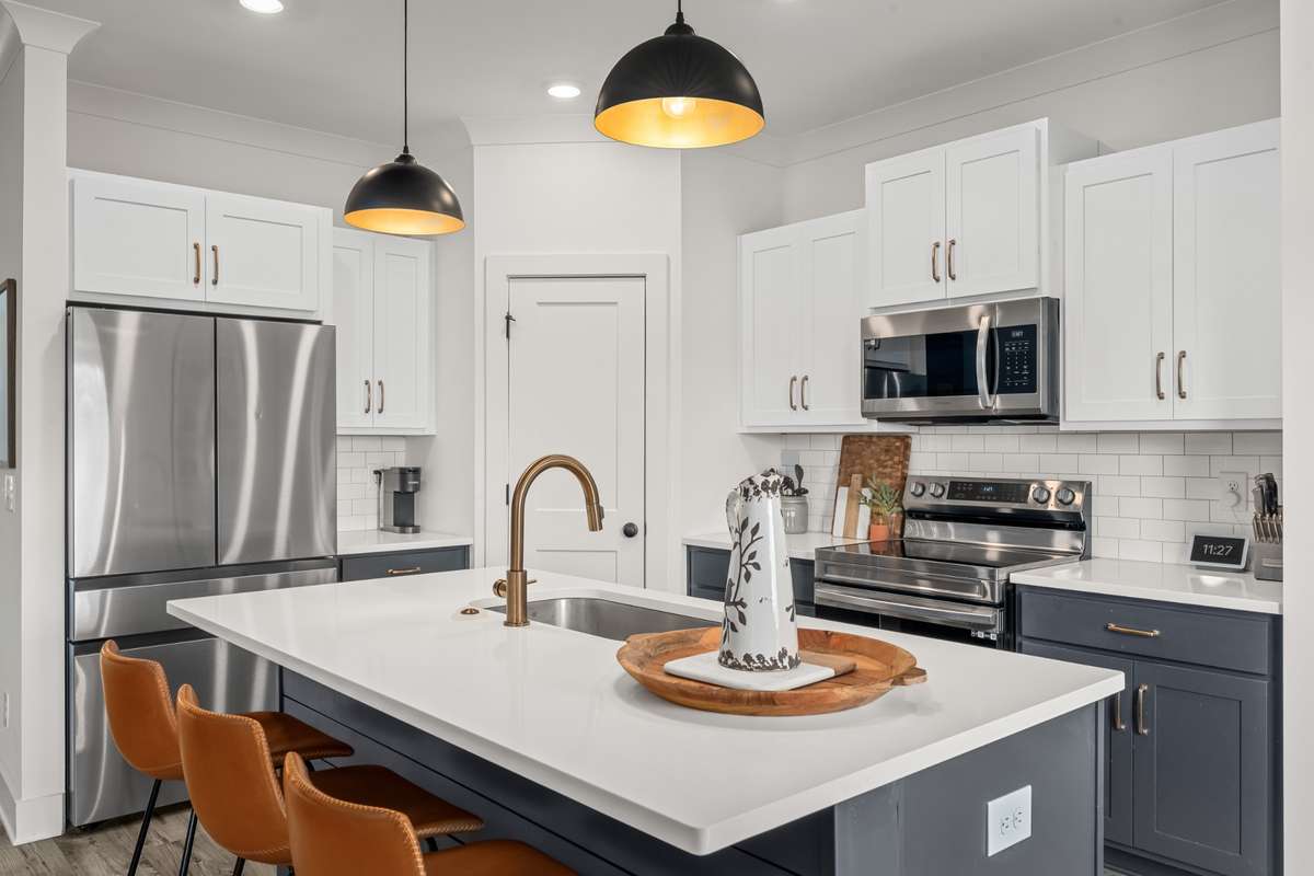 This island provides ample space for prepping food and additional seating while you are cooking.