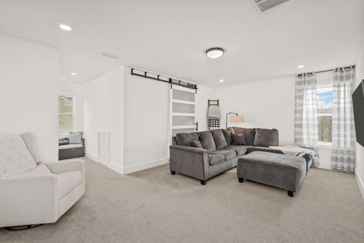 The loft area on the second level directly off of the stairs could be used as a bonus room, or additional hang out space for adults or kids. It has two dormers located in this room. One dormer has a small bench in the nook for seating.