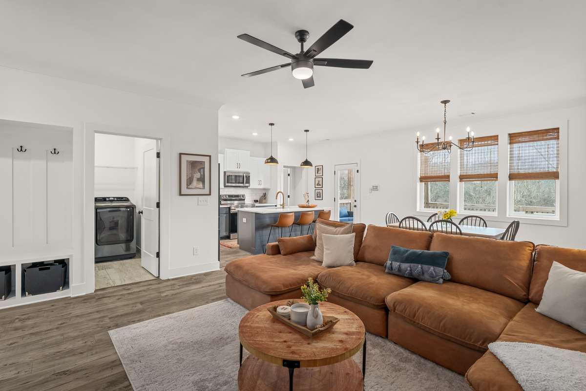A wide scale view of the open concept living area! The large windows offer bright light and a great space for entertaining.