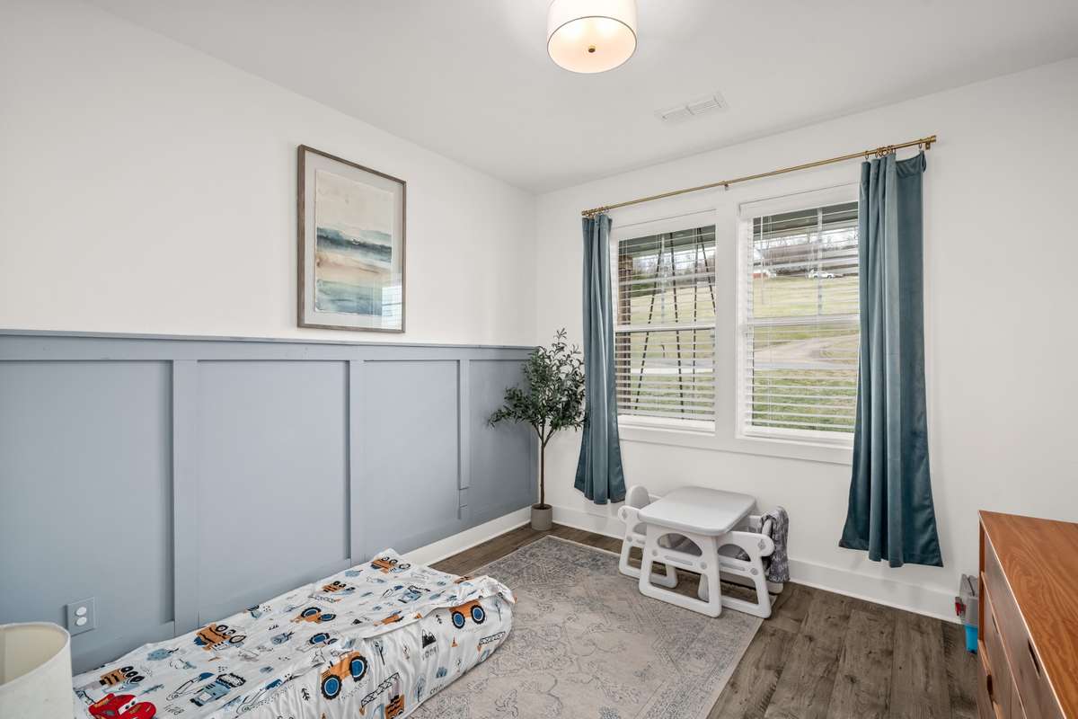 This is currently a secondary bedroom on the main, located near the front of the home but this room is versatile and could be used as an office, craft/ hobby room, etc. What could you invision in this room?