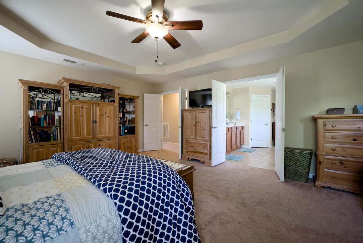 Large Primary bedroom with trey ceiling, attached primary bathroom suite and extremely large dream closet