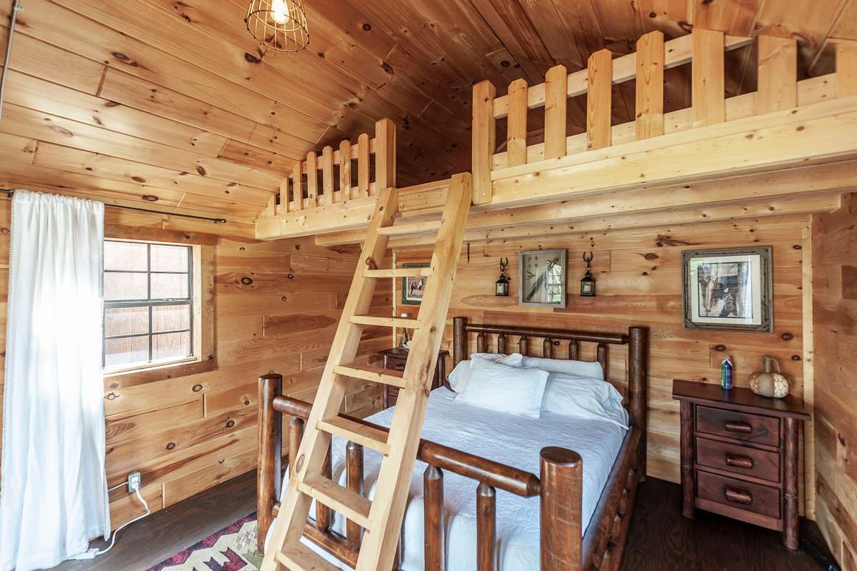 This cabin features a bedroom and loft area
