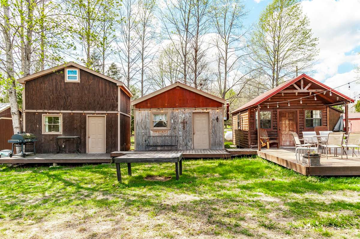 And if the 18+ acres and beautiful stone home aren't enough......a trio of cabins on the back of the property offer a perfect space for extra guest, multi-generational living or little rentals.