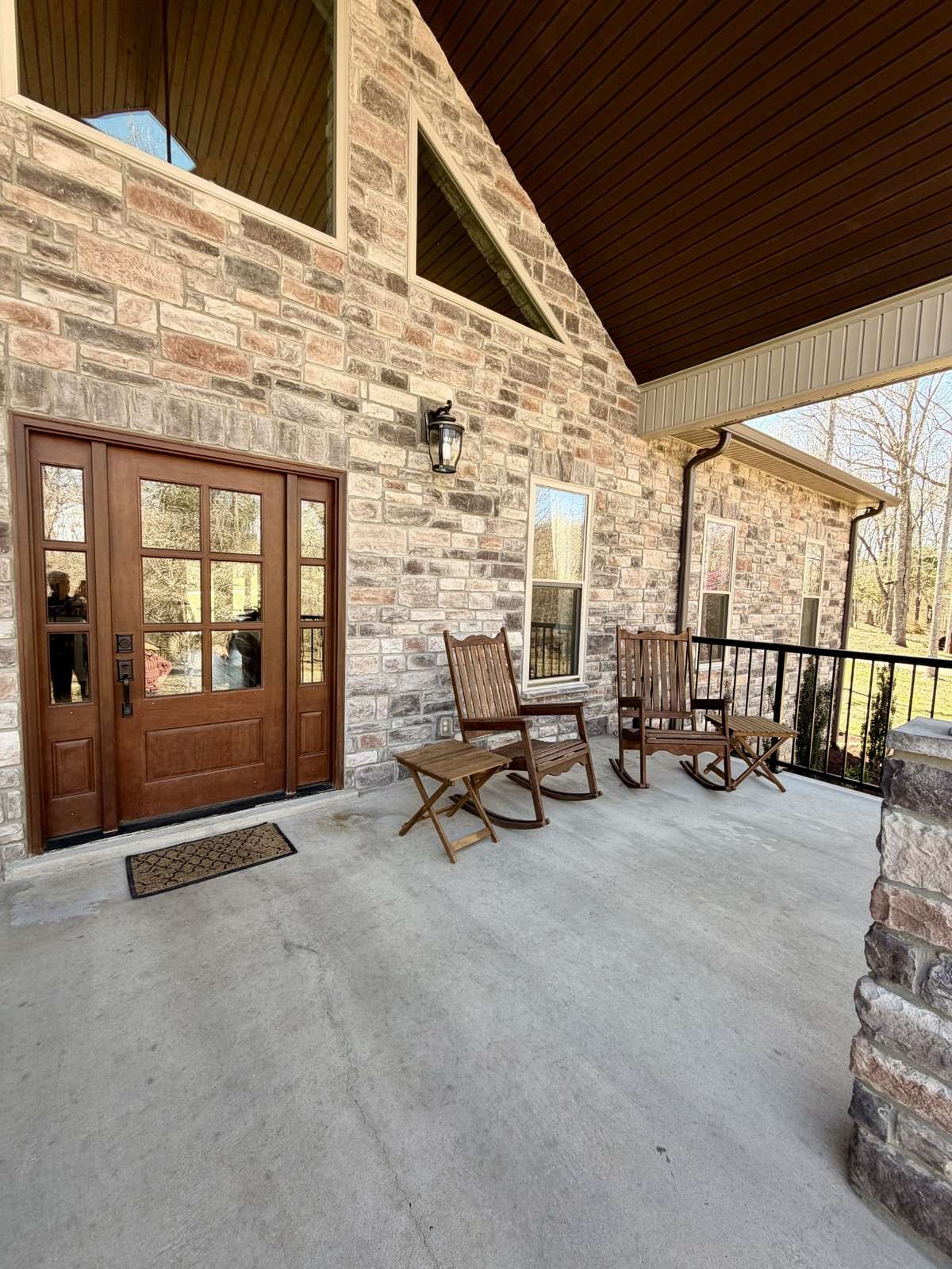 A deep front porch, perfect sitting and taking in all of the beauty.